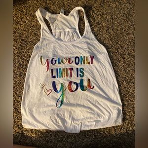 Multicolored lettering on white tank top that says “Your only limit is you”